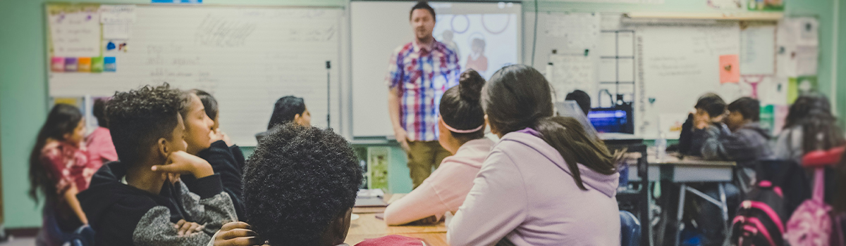 Elementary Teacher in a classroom full of students