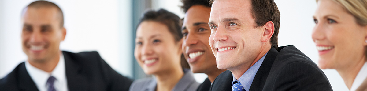 smiling business people around a table