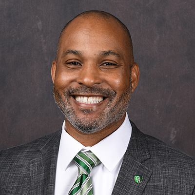 Profile photo of Chris Cribbs, Dean of Students, in front of a professional backdrop.