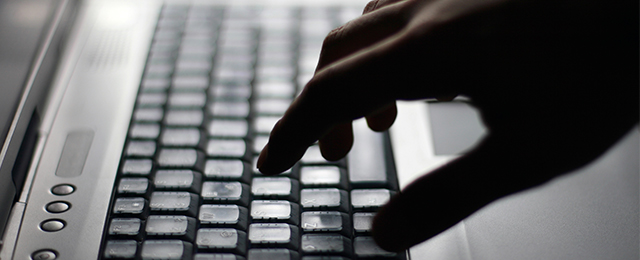 hand on computer keyboard