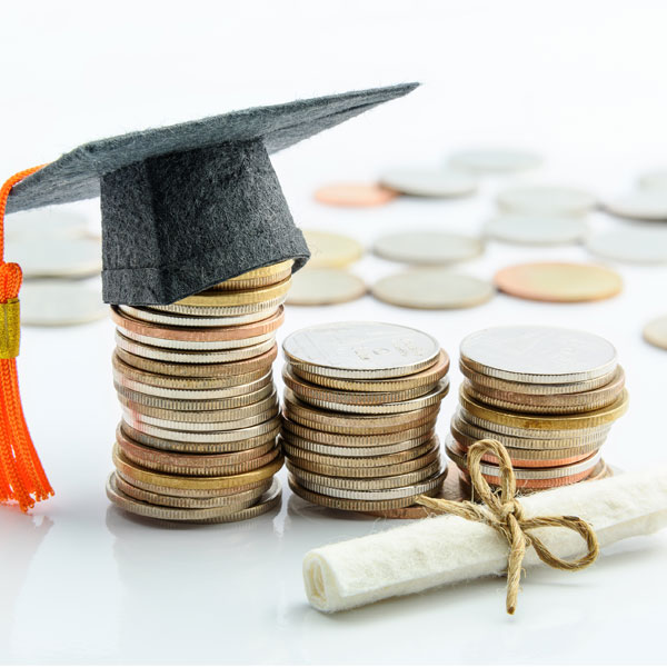 stacks of coins with small cap and diploma