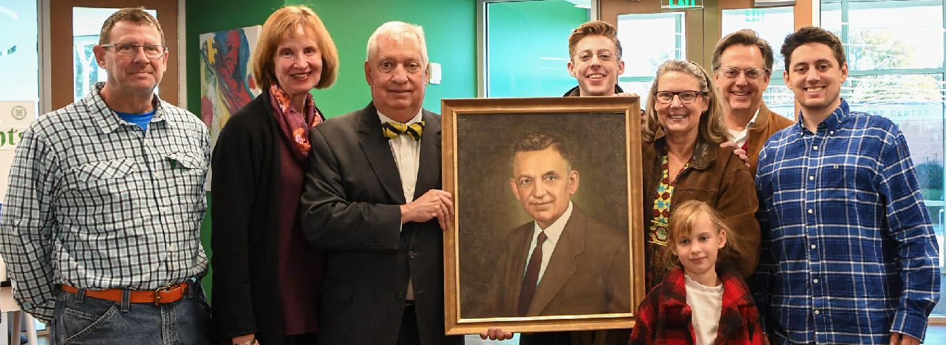 Photo Caption: Members of the Finney/Kennedy families with the recently reframed portrait of John W. Finney at the Open House. (Left to right) John Finney, great-nephew of John W. Finney; Mary Susan Kennedy, wife of Delk Kennedy; Delk Kennedy, grandson of John W. Finney; Jack Blackstone, great-grandson of John W. Finney; Elizabeth Blackstone, granddaughter of John W. Finney; Margaret Berry Kennedy, great, great-granddaughter of John W. Finney; Bill Blackstone, husband of Elizabeth Kennedy Blackstone; and Emory Blackstone, great-grandson of John W. Finney.