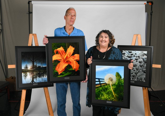 Penny and Greg May with their daughter Katherine May’s photography, which is now on display at Columbia State’s Williamson Campus.