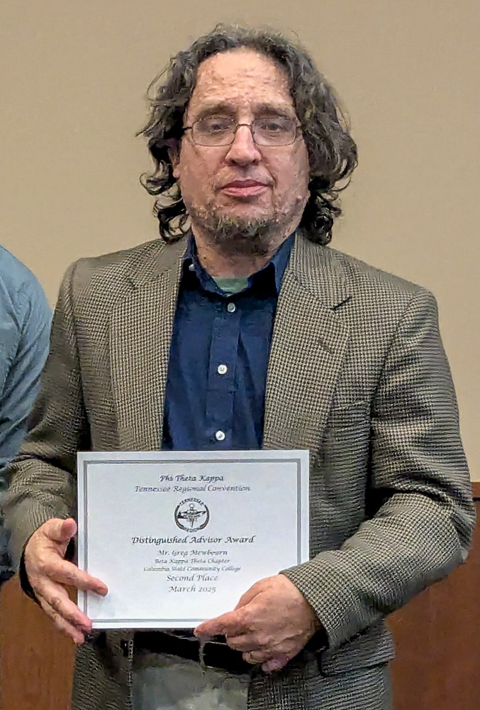 Greg Mewbourn with a PTK award