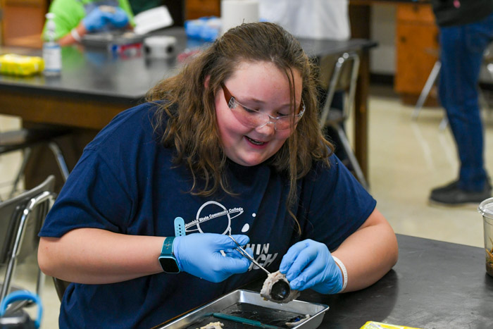 A STEM Within Reach student dissects a cow eyeball.