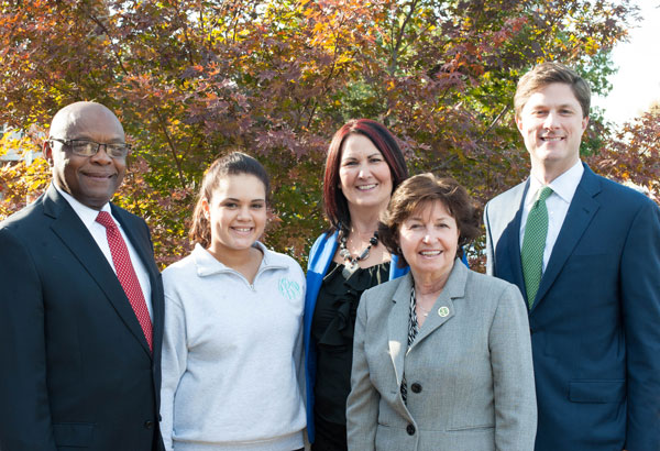 Group of five people in front of tree