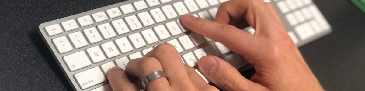 hands typing on keyboard