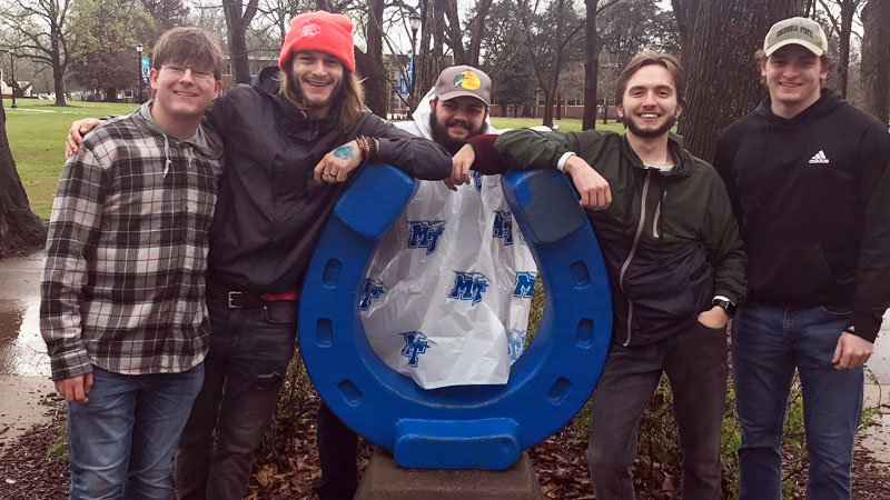 Several students with MTSU horseshoe