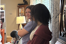 Two students smiling at each other