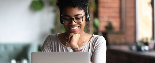 young woman with headset watching training online